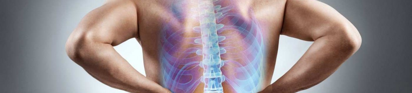 Man holding his lower back with an illustration of a spine highlighting pain or discomfort in the lower back area.