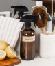 A kitchen countertop with a brown spray bottle labeled 