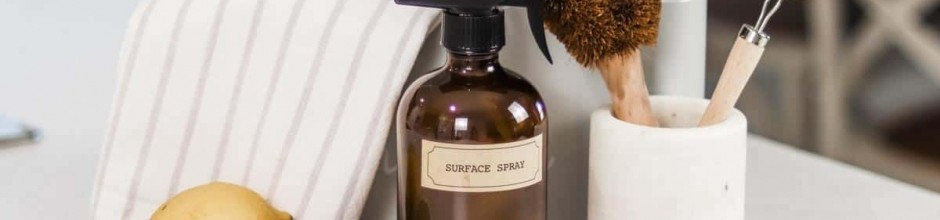 A kitchen countertop with a brown spray bottle labeled 