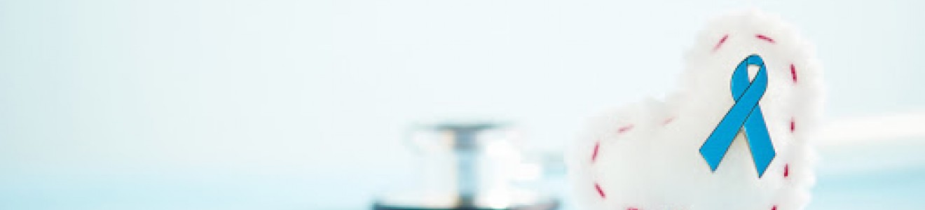 A white heart-shaped object with a blue awareness ribbon and a stethoscope on a light blue surface.